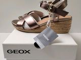 the box is open and has a pair of sandals on top of it