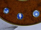 a clock that is sitting on a table with blue and white buttons