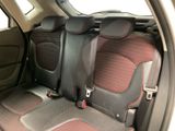 the back seats of a car with red and black trims