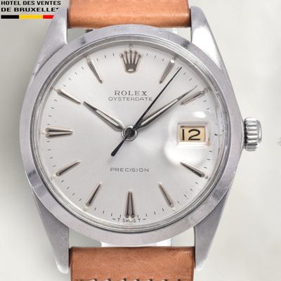 an image of a watch with a white dial and brown leather strap