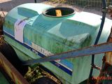 a green tank that is sitting in the dirt