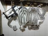a bunch of kitchen utensils hanging from the wall