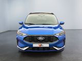 the front view of a blue car in a white room