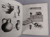 an open book with drawings of pottery on it