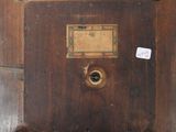 a wooden box with a label on it on the floor