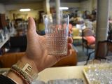 a person holding a glass of water in their hand