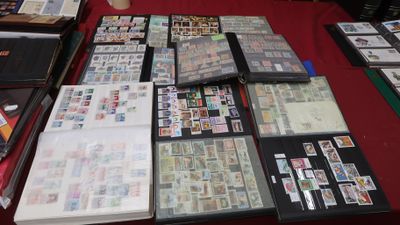 a lot of stamps on a table with a red table cloth