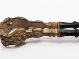 a black and gold dagger on a white surface