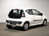a picture of a small white car parked in a garage