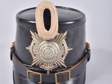 a black hat with a gold badge on it