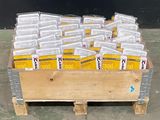 a wooden crate filled with packets of food on a pallet