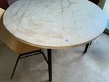 a round table with chairs around it in a room