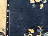 an image of a close up of a blue rug with yellow and blue flowers
