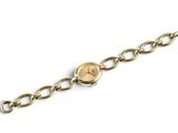 a close up of a watch on a chain on a white surface