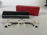 pair of glasses and case on a white surface with a red box
