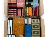 boxes of books are stacked on top of each other on a white surface