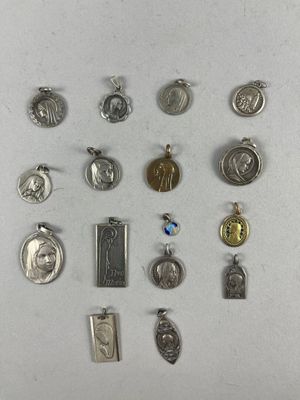 many different types of religious charms on a white surface