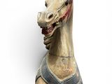a wooden horse with a harness on it ' s head