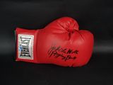a close up of a red boxing glove on a black background