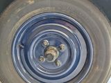 a tire that has been painted blue and has a hole in the tire