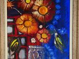 tableau représentant des fleurs dans un vase sur fond bleu, avec un cadre doré