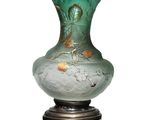 a green glass vase with a gold leaf design on it