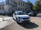 a white car that is parked in front of a building