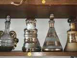a shelf that has a lot of glass bottles on it