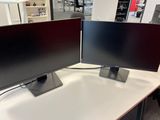 two monitors sitting on a table in a store