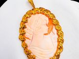 a picture of a woman in a cameo pendant on a white plate