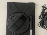 an image of a black tablet with a charger and a cord