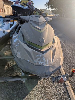 a boat that is sitting on a trailer on the side of the road
