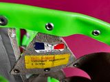 a close up of a green bicycle with a credit card in the seat