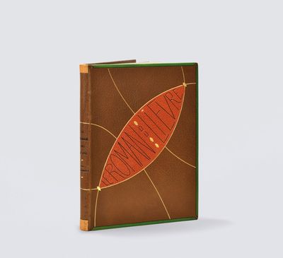 a brown and green book with a leaf design on the cover