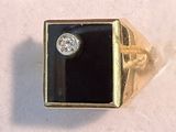 yellow gold ring with a black stone and a white diamond