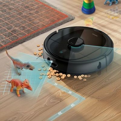 a robot that is sitting on the floor next to a toy dinosaur