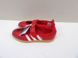 red and white baby shoes with a tag on the sole