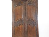 an image of a wooden armoire with carvings on the doors