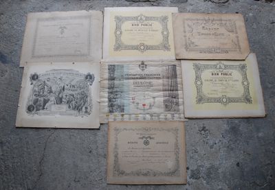 several old books sitting on top of a cement floor next to each other