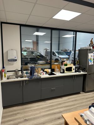 an image of a kitchen with a lot of clutter on the counter
