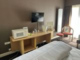 a bed with a white comforter and a microwave on it