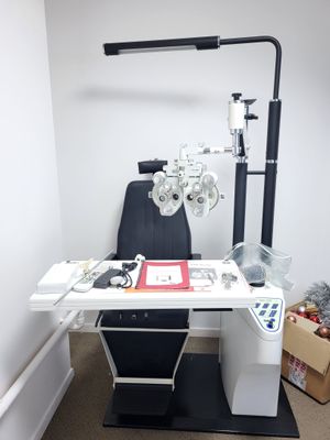 a desk with a computer and a pair of glasses on it