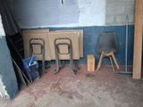 two chairs and a table in the corner of a room