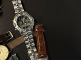 a lot of different watches on a black table