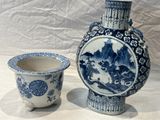 two vases sitting next to each other on a table