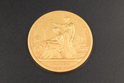 une image représentant une pièce d'or sur laquelle figurent une femme et un homme