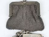 an old silver purse with a chain around it and a chain around the clasp