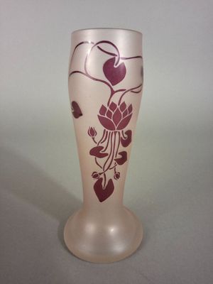 a glass vase with a design on it sitting on a table