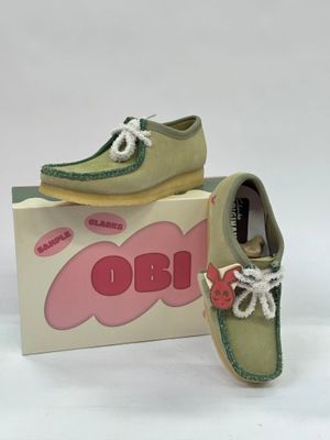 pair of children ' s shoes in a box on a white surface