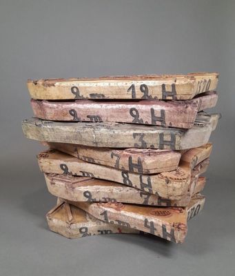 several pieces of wood stacked on top of each other with writing on them